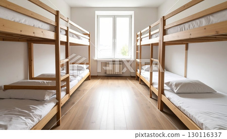 Luxurious hotel bedroom interior with a comfortable bed, elegant furniture, and a large window Luxurious hotel bedroom interior with a comfortable bed, elegant furniture, and a large window 130116337