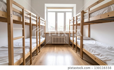 Luxurious hotel bedroom interior with a comfortable bed, elegant furniture, and a large window Luxurious hotel bedroom interior with a comfortable bed, elegant furniture, and a large window 130116338