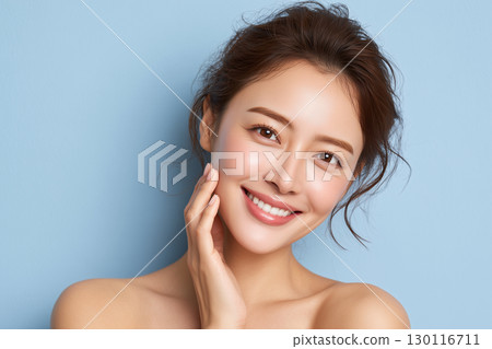 Brightly smiling face of a beautiful young woman. Close-up of a woman's smile with radiant skin after skin care. Brightly smiling face of a beautiful young woman. Close-up of a woman's smile with radiant skin after skin care. 130116711