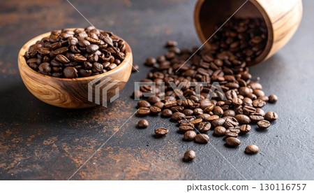Closeup of roasted brown coffee beans overflowing from a white cup Closeup of roasted brown coffee beans overflowing from a white cup 130116757