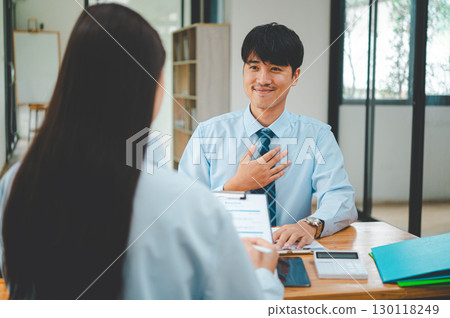 Job applicant introducing himself For a job interview after submitting a resume document to the Human Resources Manager for consideration for employment in the company. 130118249