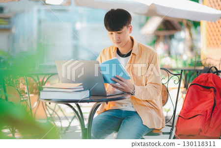 Students are doing research and finding knowledge on the internet on laptops in the university area. 130118311