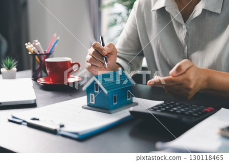Real estate agent agree to buy home to clients agency office. House model, real estate agent, customer discussing for contract to buy house, insurance, loan real estate background. Concept agreement. 130118465
