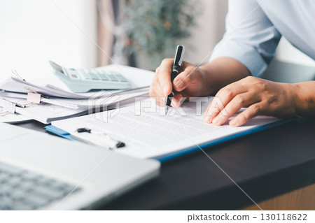 Business person with contract law and paper work for business finance, loan application form, contract real estate and insurance concept. signing contract, working on desk, business document Business person with contract law and paper work for business finance, loan application form, contract real estate and insurance concept. signing contract, working on desk, business document 130118622