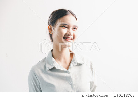 Asian woman rejoicing, looking happy, champion, fist pump gesture, standing over white background. young woman had happy, positive expression on her face, highlighted by bright smile. Asian woman rejoicing, looking happy, champion, fist pump gesture, standing over white background. young woman had happy, positive expression on her face, highlighted by bright smile. 130118763