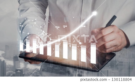 Business professional analyzing financial data on digital tablet with growth chart and city skyline in background, modern office concept Copula 130118804