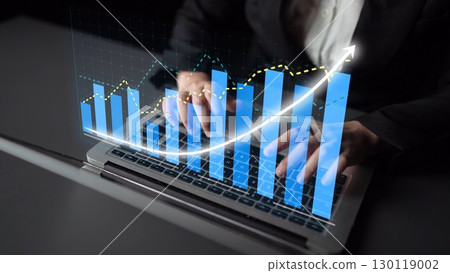 Businessman using laptop with digital financial growth chart, holographic display, data analysis, and technology in modern office environment Copula 130119002