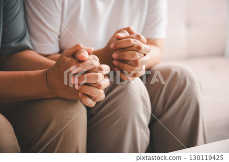 Hope and trust with crisis concept. Closeup, love and holding hands for support, comfort and care with grief, loss and empathy. people and family with compassion, sympathy and healing with bonding. 130119425