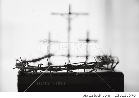 Crown of thorns and cross powerful symbols in Christianity, representing holy sacrifice of Jesus Christ in Bible and serving as enduring reminders of faith and core of Christian religion. Crown of thorns and cross powerful symbols in Christianity, representing holy sacrifice of Jesus Christ in Bible and serving as enduring reminders of faith and core of Christian religion. 130119576