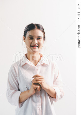 Asian woman rejoicing, looking happy, champion, fist pump gesture, standing over white background. young woman had happy, positive expression on her face, highlighted by bright smile. Asian woman rejoicing, looking happy, champion, fist pump gesture, standing over white background. young woman had happy, positive expression on her face, highlighted by bright smile. 130119706