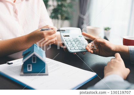 Woman real estate sale agent, client after signing agreement contract real estate with approved mortgage application form concerning mortgage loan offer, house insurance. contract agreement in office Woman real estate sale agent, client after signing agreement contract real estate with approved mortgage application form concerning mortgage loan offer, house insurance. contract agreement in office 130119707