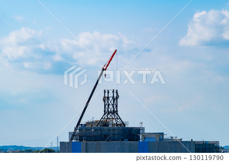 Assembly of steel tower and building under construction a-1 Assembly of steel tower and building under construction a-1 130119790