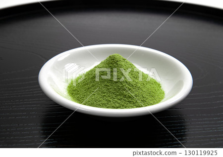 Matcha green tea served on a small plate 130119925