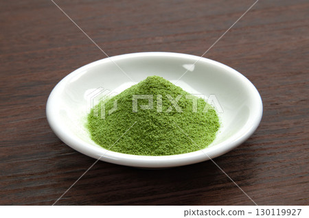 Matcha green tea served on a small plate 130119927