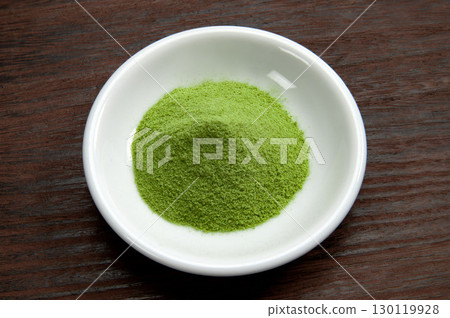 Matcha green tea served on a small plate 130119928