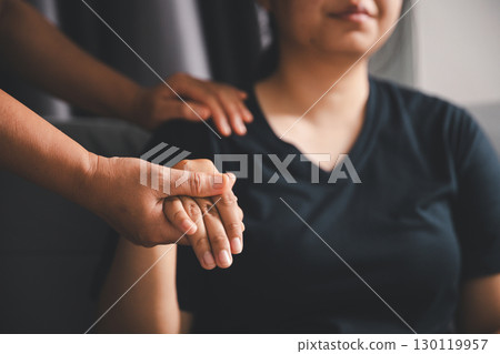 Hope and trust with crisis concept. Closeup, love and holding hands for support, comfort and care with grief, loss and empathy. people and family with compassion, sympathy and healing with bonding. 130119957