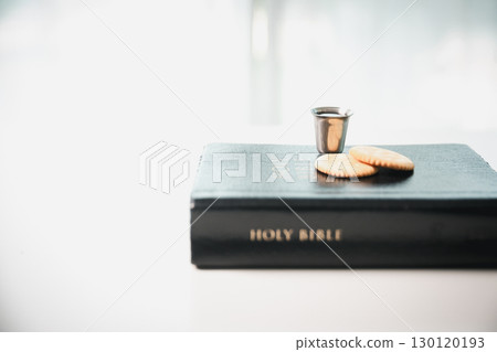 Christianity, holy communion ceremony is sacred act of worship and faith, where bread and wine in chalice symbolize body and blood of Christ in the religious eucharist tradition. 130120193