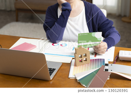 Senior woman thinking about home renovations and second life (no face) 130120391