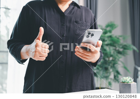 Closeup of woman holding smartphone hand shows using mobile phone technology browse online shopping, social media, engaging in fast-paced world of cyberspace. online shopping, social media network 130120848