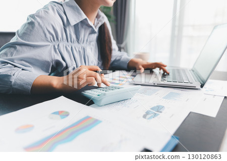 Business woman analyze calculate company financial, tax results office accounting statistics analytical research. calculating business balance prepare tax reduction. Tax deduction planning concept. 130120863