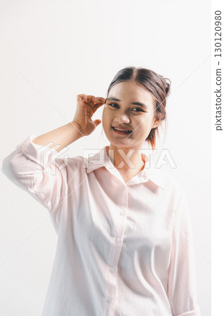 Asian woman rejoicing, looking happy, champion, fist pump gesture, standing over white background. young woman had happy, positive expression on her face, highlighted by bright smile. Asian woman rejoicing, looking happy, champion, fist pump gesture, standing over white background. young woman had happy, positive expression on her face, highlighted by bright smile. 130120980