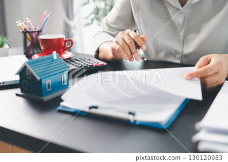 Real estate agent agree to buy home to clients agency office. House model, real estate agent, customer discussing for contract to buy house, insurance, loan real estate background. Concept agreement. Real estate agent agree to buy home to clients agency office. House model, real estate agent, customer discussing for contract to buy house, insurance, loan real estate background. Concept agreement. 130120983