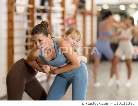 Young women in self-defense training Young women in self-defense training 130121353