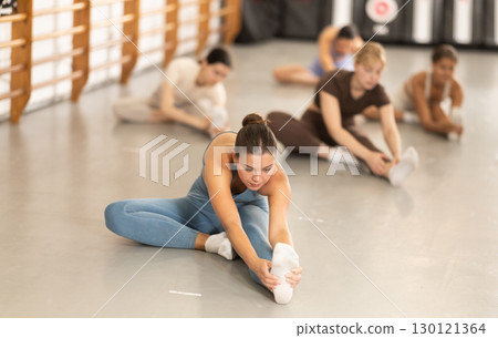 Young women doing muscle stretching 130121364