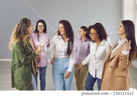 Group of multiracial businesswomen talking and laughing together Group of multiracial businesswomen talking and laughing together 130121412