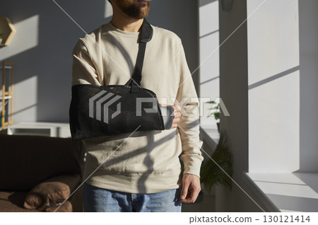 Cropped shot of man with broken arm in plaster cast 130121414