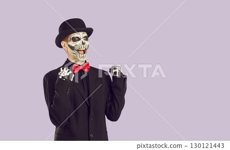 Grimacing Skeleton man in studio, joy, cry of victory. Isolated image on lilac background 130121443
