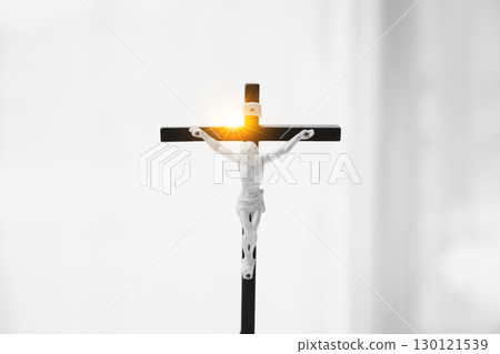 Religious person gazes at holy crucifix, seeing the hand of Jesus Christ, the crown of thorns, and the cross as powerful symbols of faith, God, and the foundation of their religion. Religious person gazes at holy crucifix, seeing the hand of Jesus Christ, the crown of thorns, and the cross as powerful symbols of faith, God, and the foundation of their religion. 130121539