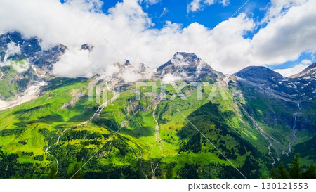 Grossglockner, Austria Breathtaking Alpine Scenery of Lush Green Mountains and Cloudy Skies 130121553