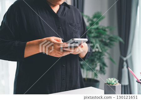 Closeup of woman holding smartphone hand shows using mobile phone technology browse online shopping, social media, engaging in fast-paced world of cyberspace. online shopping, social media network Closeup of woman holding smartphone hand shows using mobile phone technology browse online shopping, social media, engaging in fast-paced world of cyberspace. online shopping, social media network 130121651