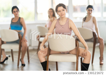 Young girl performing sass dance with chair at group class 130121672