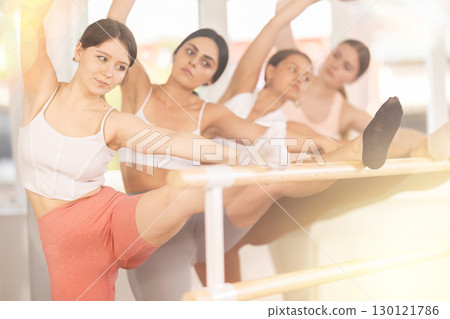 Ballet pose grand batman - young ballerinas at choreography lesson 130121786