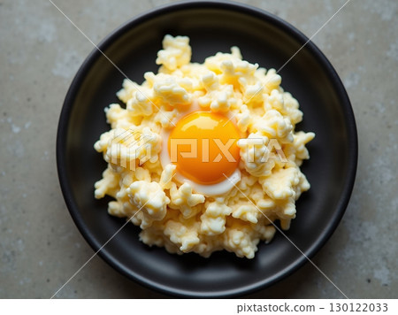 Top view Minimalist Scrambled Egg Gourmet Cuisine on Black Plate Top view Minimalist Scrambled Egg Gourmet Cuisine on Black Plate 130122033