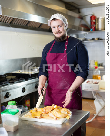 Store worker preparing raw chicken for cooking in ready-to-eat food section 130122205