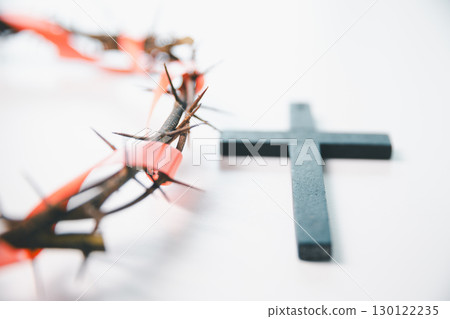 Cross and crown of thorns, often seen in gold crucifix symbols, represent the sacrifice of Jesus Christ-central to Easter message and the foundation of faith in the Christian religion. 130122235