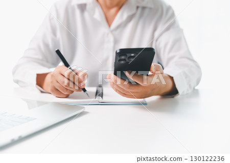Close-up businesswoman using smart mobile phone at office table, female student is home studying online e-learning, searching for information on internet, engaging with social networks. 130122236