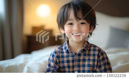 Smiling boy in pajamas in his bedroom 130122239