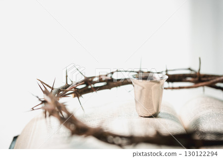 Christianity, holy communion ceremony is sacred act of worship and faith, where bread and wine in chalice symbolize body and blood of Christ in the religious eucharist tradition. 130122294