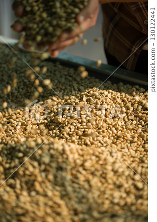 Close up smart farmer techniques hand coffee bean machinery roast apparatus dry sunlight tool sunbeam sunray sunshine fresh garden produce agriculture promotes farmer concept farm blur background 130122441