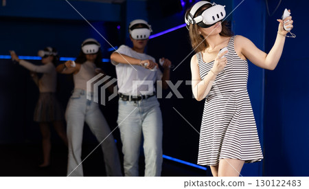 Young girl interacting with immersive environment of virtual reality world 130122483