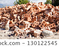 Pile of red clay bricks outdoors 130122545