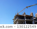 Concrete structure and construction pump working under bright blue sky 130122549