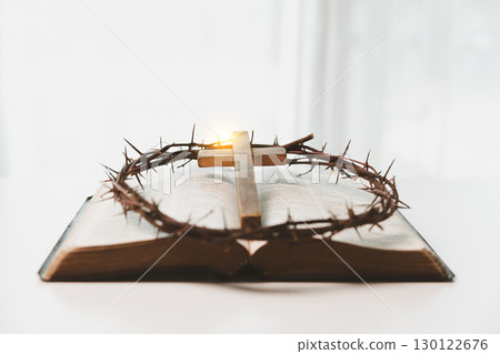 Crown of thorns and cross powerful symbols in Christianity, representing holy sacrifice of Jesus Christ in Bible and serving as enduring reminders of faith and core of Christian religion. 130122676