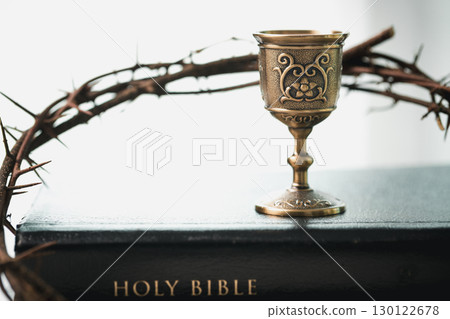 Christianity, holy communion ceremony is sacred act of worship and faith, where bread and wine in chalice symbolize body and blood of Christ in the religious eucharist tradition. 130122678