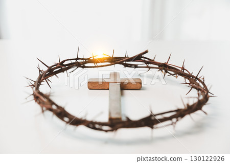 Cross and crown of thorns, often seen in gold crucifix symbols, represent the sacrifice of Jesus Christ-central to Easter message and the foundation of faith in the Christian religion. Cross and crown of thorns, often seen in gold crucifix symbols, represent the sacrifice of Jesus Christ-central to Easter message and the foundation of faith in the Christian religion. 130122926