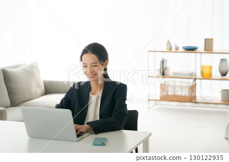 A woman using a computer 130122935